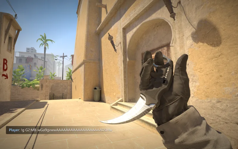 A Karambit Damascus Steel held in first person on Mirage, with the gen code that spawned it in chat